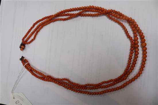 A triple strand graduated coral bead necklace, gross weight 51 grams, 50cm.